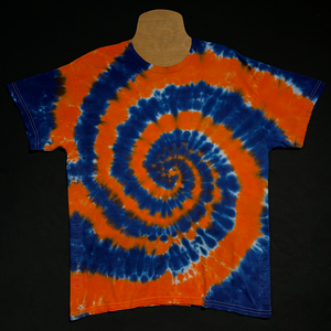 Front side of a Detroit Tigers colors spiral tie dye t-shirt; laid flat on a solid black background