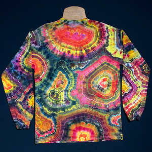 Back side of the first pink, black & yellow agate geode reminiscent ice tie-dyed long sleeve shirt design; laid flat on a solid black background