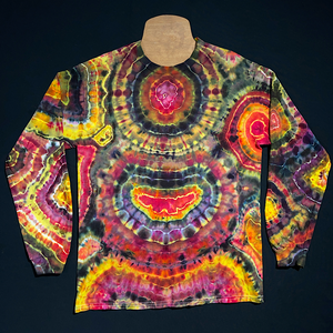 Front side of a second, different, black, pink & yellow agate geode inspired long sleeve ice tie-dyed shirt design; laid flat on a solid black background