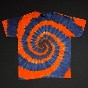 Youth sized orange & dark blue Detroit Tigers spiral tie dye t-shirt; laid flat on a solid black background.
