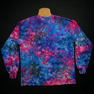 Back side of the same Cloud 9 blue, pink & purple marbled splatter ice tie-dyed long sleeve shirt design; laid flat on a solid black background