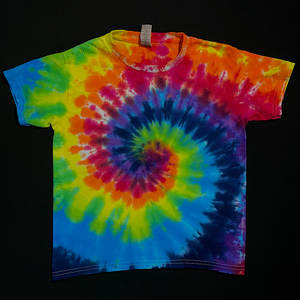 A different, finished, one-of-a-kind ROYGBIV rainbow spiral tie dye t-shirt design in a youth size; laid flat on a solid black background