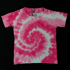 An example of a finished, one-of-a-kind, hand-dyed when ordered toddler sized tie dye shirt design, featuring bright bubblegum pink & white in a classic spiral design; laid flat on a solid black background