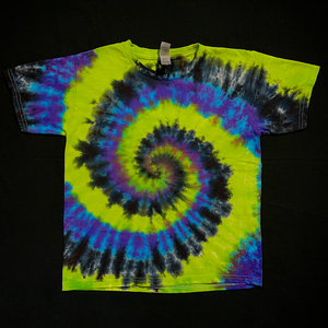 An example of a finished toddler sized black, green & purple spiral tie dye short sleeve t-shirt; laid flat on a solid black background