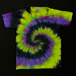 An example of a finished, hand-dyed black ,green & purple spiral short sleeve tie dye t-shirt; laid flat on a solid black background