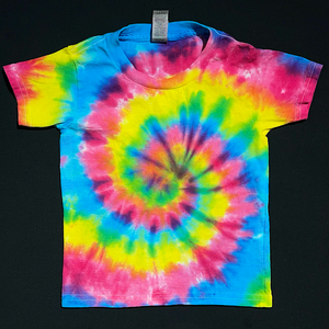 A toddler sized short sleeve t-shirt featuring a hot pink, fluorescent yellow & electric blue tie-dyed spiral design; laid flat on a solid black background.