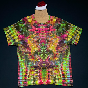Another example of a Merry Mindscape ice tie-dyed t-shirt; laid flat on a solid black background