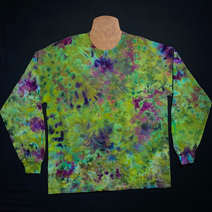 Another example of a different, finished weed bud inspired green & purple marbled ice dye splatter long sleeve shirt; laid flat on a solid black background