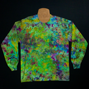 Front side of a marijuana bud inspired tie dye splatter design featuring green and purple shades, in a speckled pattern reminiscent of a weed nug