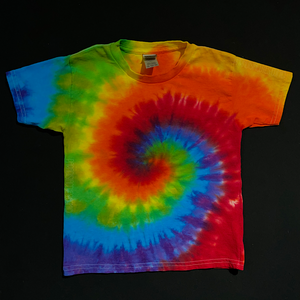 a Pride flag rainbow spiral tie dye short sleeve tee, laid flat on a solid black background.