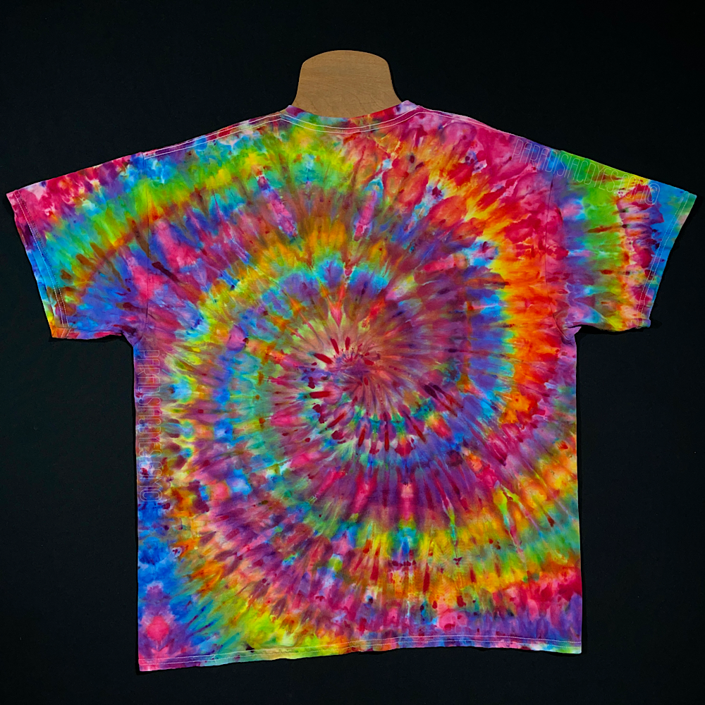 Front side of a rainbow confetti spiral ice dyed design on a short sleeve, crewneck style Gildan Ultra Cotton t-shirt. Each handmade-to-order tie dye shirt design comes out totally unique and is genuienly one of a kind.