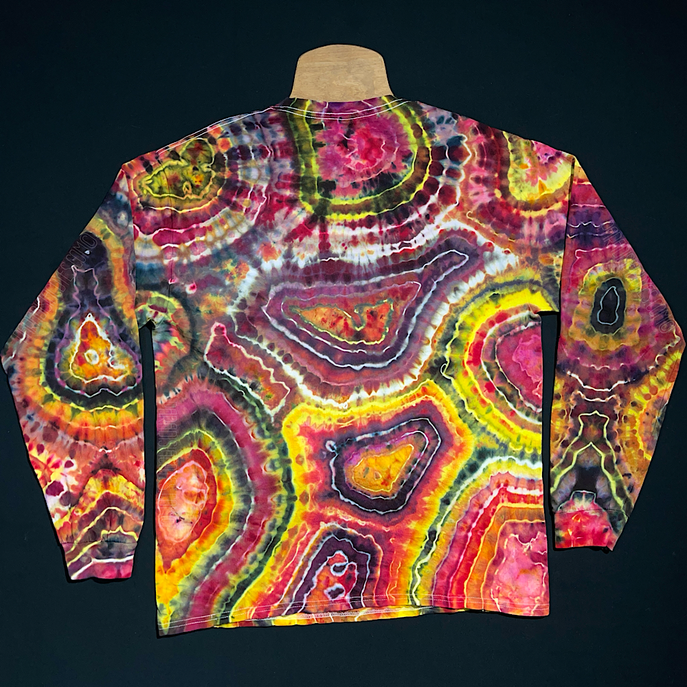 Back side of the second, different, black, pink & yellow agate geode inspired long sleeve ice tie-dyed shirt design; laid flat on a solid black background 