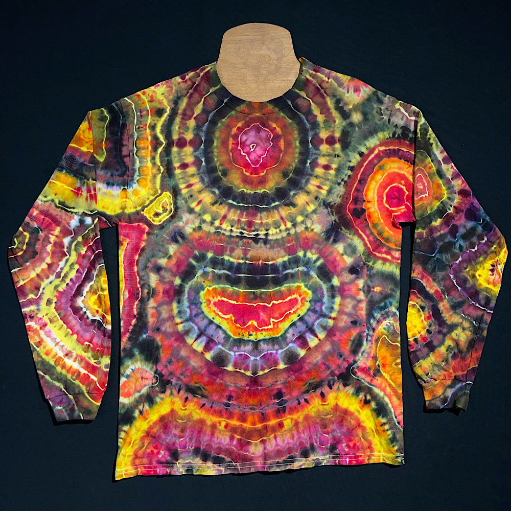 Front side of a second, different, black, pink & yellow agate geode inspired long sleeve ice tie-dyed shirt design; laid flat on a solid black background 