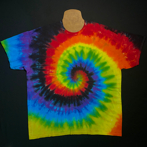 An example of a finished, one-of-a-kind, hand-dyed when ordered rainbow tie dye t-shirt, featuring: red, orange, yellow, green, blue, purple & black in a spiral design