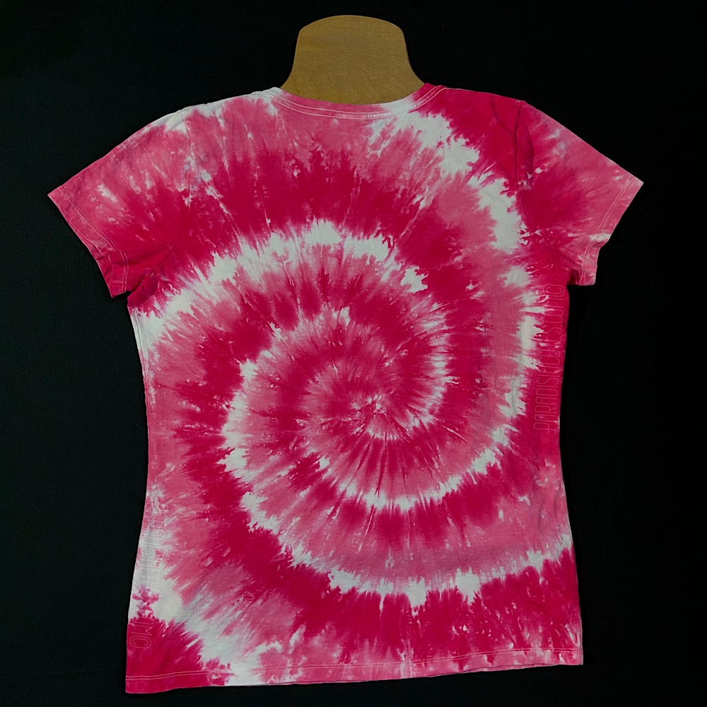 Front side of a women's v-neck style short sleeve t-shirt featuring a bubblegum pink & white spiral tie dye design; laid flat on a solid black background 