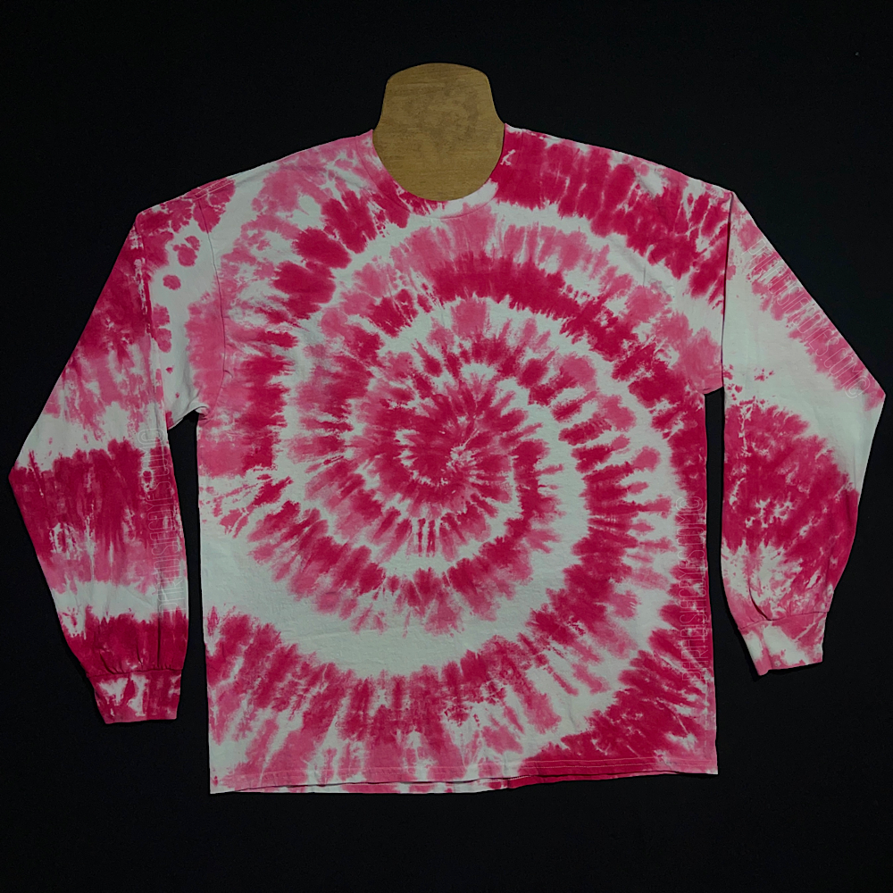 An example of a finished Bubblegum pink spiral long sleeve tie dye shirt; laid flat on a solid black background 