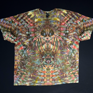 Abstract tie dye t-shirt featuring earthy, camouflage inspired colors in a symmetrical, totem pole reminiscent pattern.