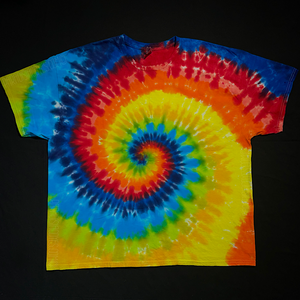 Front side of a Classic rainbow spiral tie dye short sleeve shirt; laid flat on a solid black background