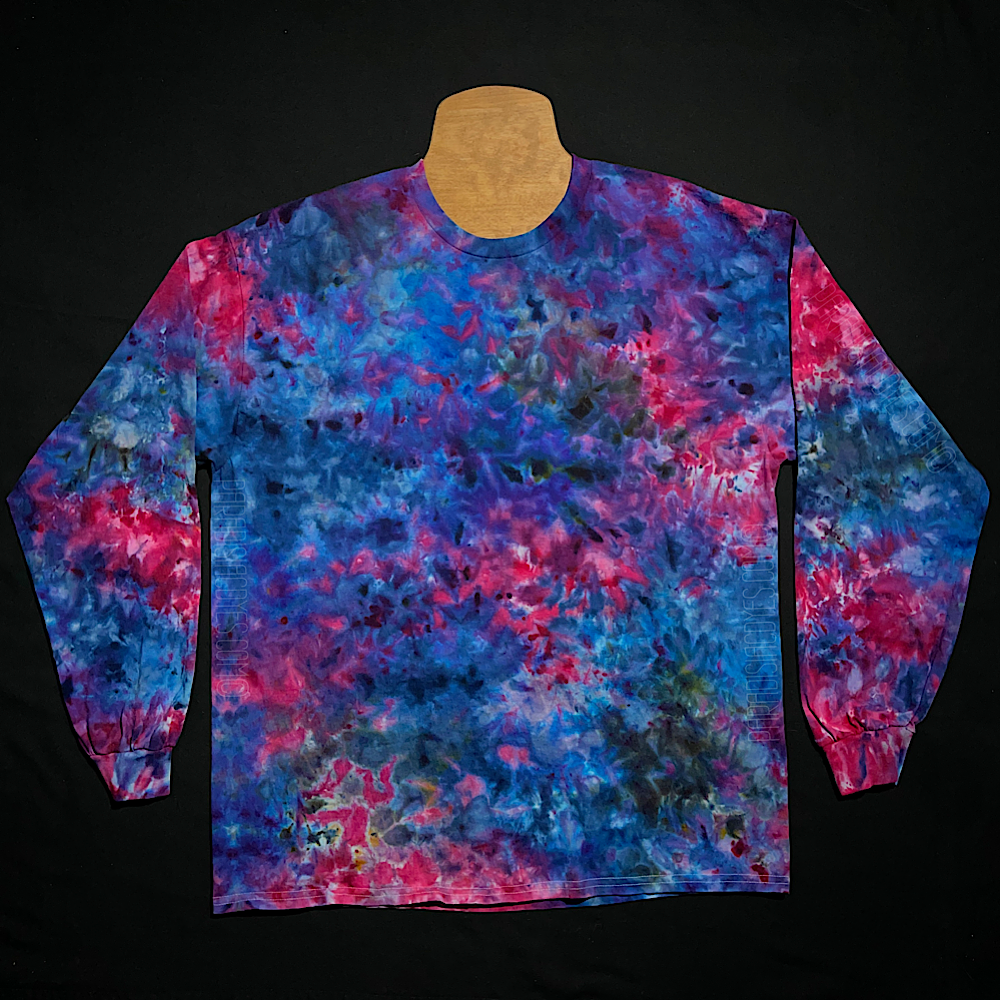 Front side of a blue, pink & purple marbled ice tie-dyed splatter design long sleeve shirt; laid flat on a solid black background 