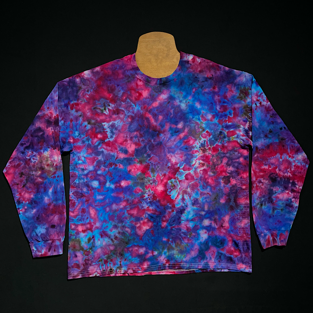 A finished long sleeve cloud 9 marbled ice tie-dyed design; laid flat on a solid black background.