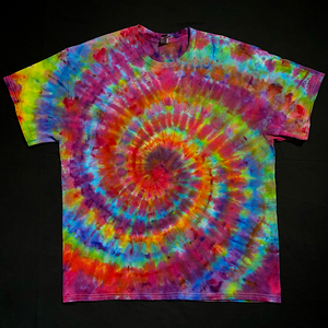 Another example of a finished, one-of-a-kind Rainbow Confetti Ice Dye Spiral T-Shirt design; a rainbow color scheme featuring primarily pinks, with blues, yellows, neon lime green, purple & peach shades