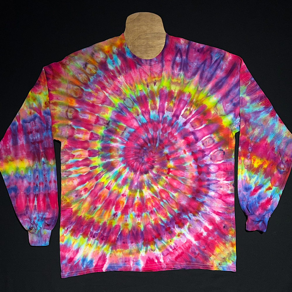 Primarily pink multicolor-rainbow ice tie-dyed spiral long sleeve shirt design; laid flat on a solid black background.