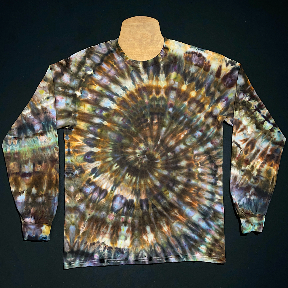 An earthy, rustic ice tie-dyed spiral design featuring an array of brown & gray shades on a 100% pre-shrunk cotton long sleeve shirt; laid flat on a solid black background.