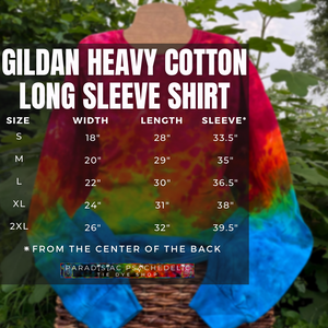 Gildan Heavy Cotton Long Sleeve Shirt size chart graphic with width by length measurements (in inches) of adult sizes SM-2XL, with a marbled rainbow ice dye splatter long sleeve shirt displayed in the background 