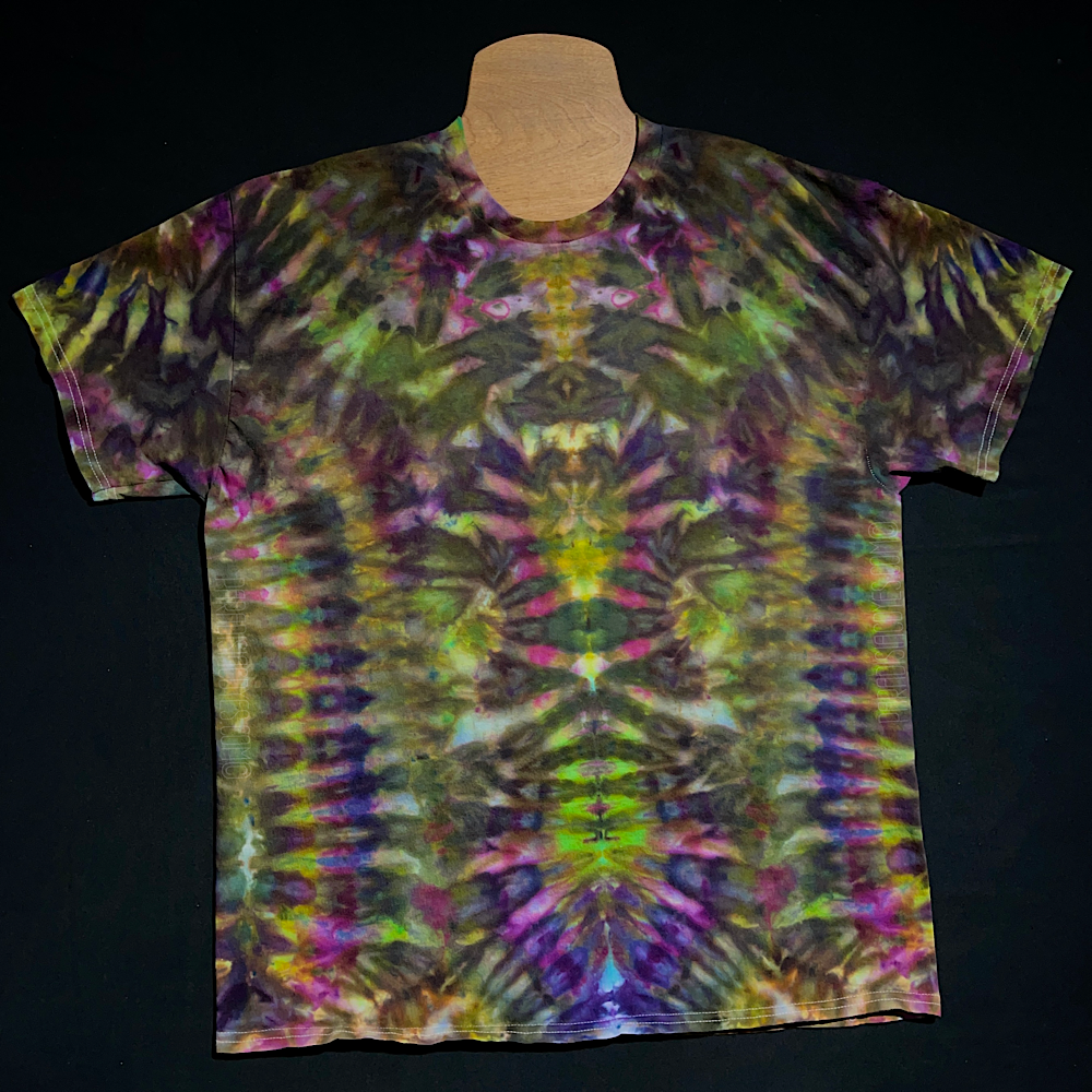 Front side of a Psychedelic Mindscape ice tie dyed shirt design in a Halloween themed green & purple color scheme; featuring an abstract, symmetrical, totem pole reminiscent pattern