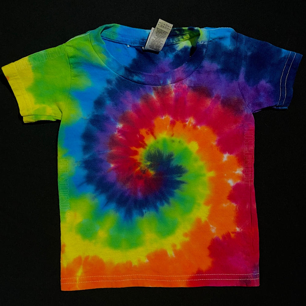 Another example of a finished, one-of-a-kind ROYGBIV rainbow spiral toddler tie dye t-shirt; laid flat on a solid black background 