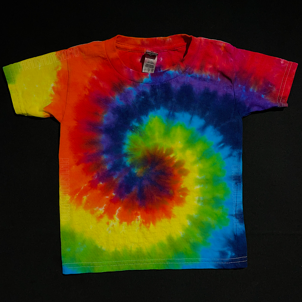 Another different, finished, one-of-a-kind ROYGBIV rainbow spiral tie dye design on a toddler sized tee; laid flat on a solid black background 