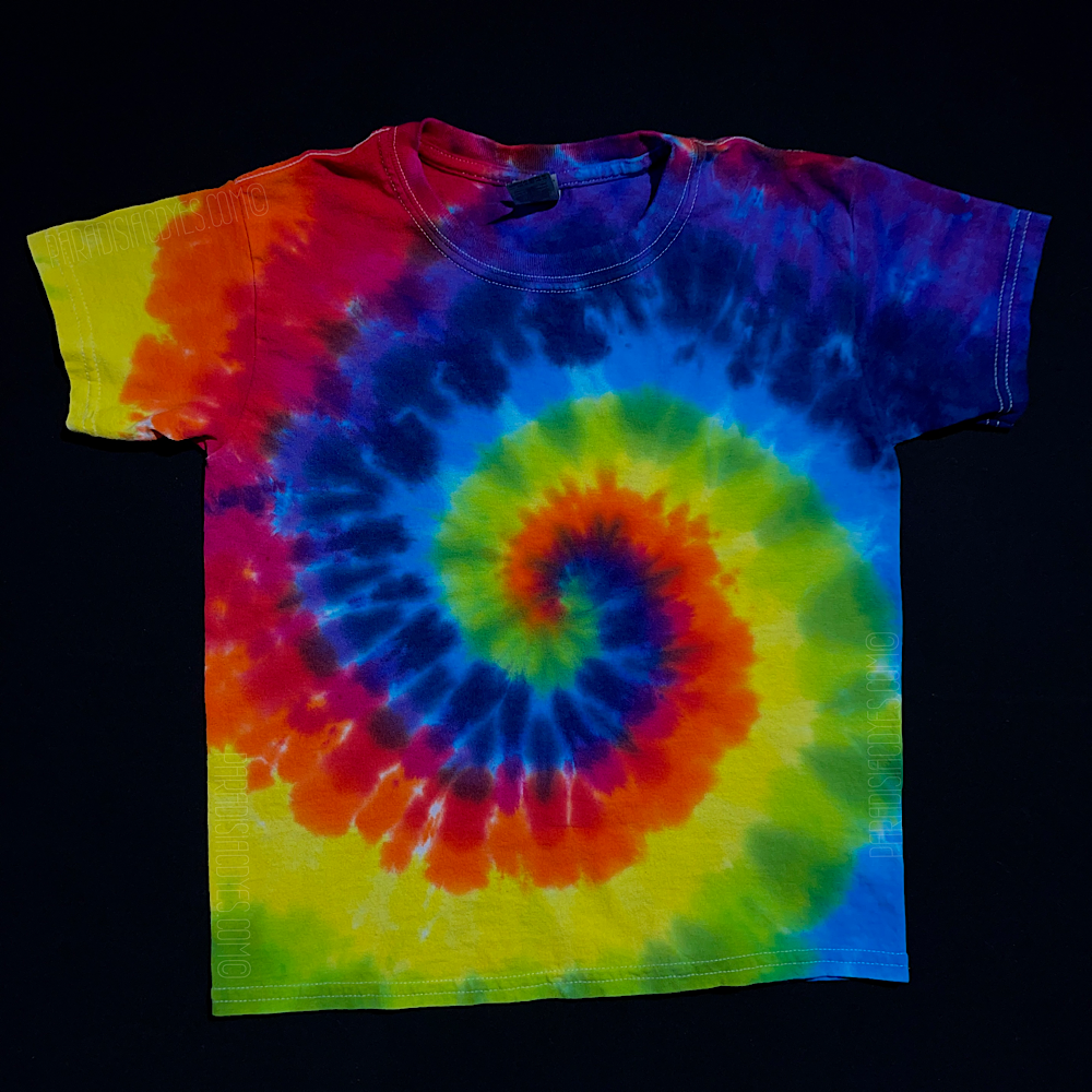 An example of a children's size ROYGBIV rainbow spiral tie dye t-shirt; laid flat on a solid black background 