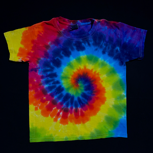 An example of a children's size ROYGBIV rainbow spiral tie dye t-shirt; laid flat on a solid black background 