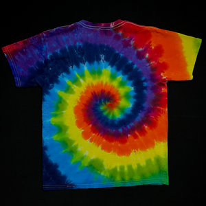 Back side of s handmade-to-order, one-of-a-kind, Children's size ROYGBIV rainbow spiral tie dye t-shirt design; laid flat on a solid black background