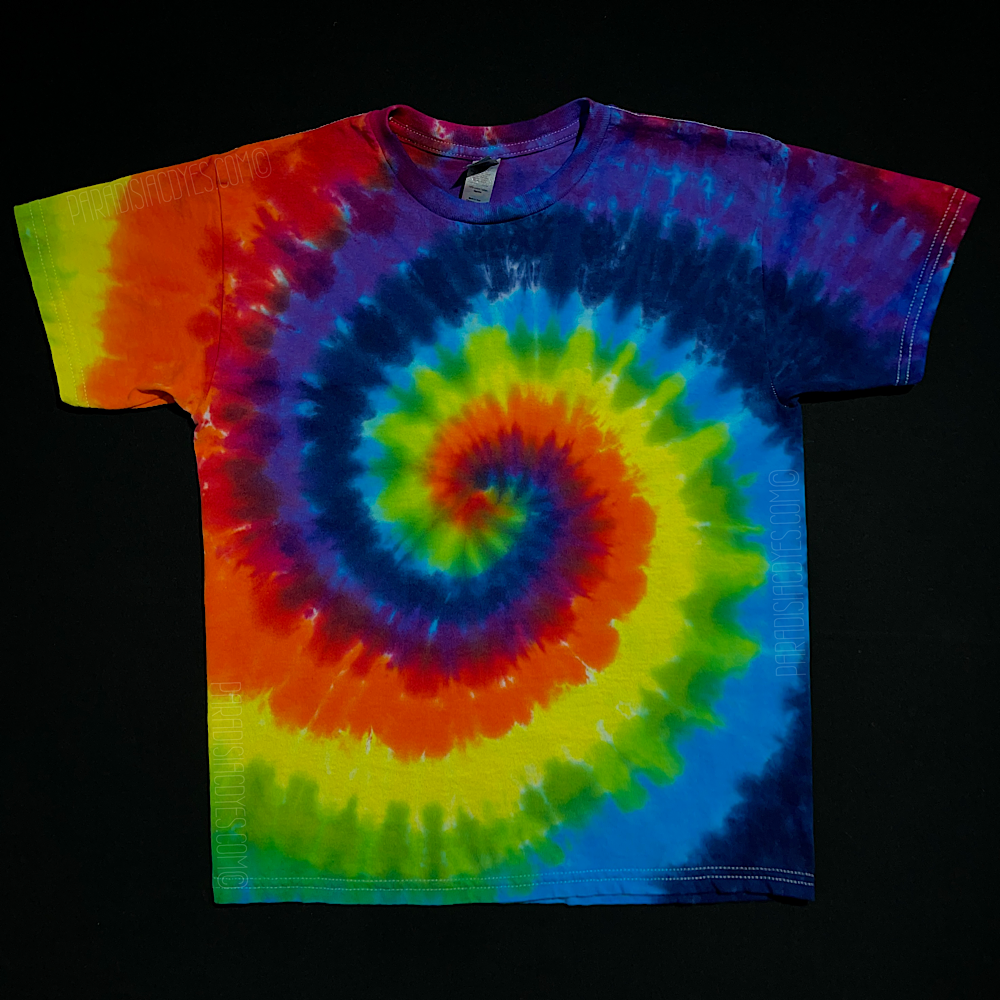 A handmade-to-order, one-of-a-kind, youth sized ROYGBIV rainbow spiral short sleeve tie dye shirt design, featuring: red, orange, yellow, green, blue, indigo & violet; laid flat on a solid black background 