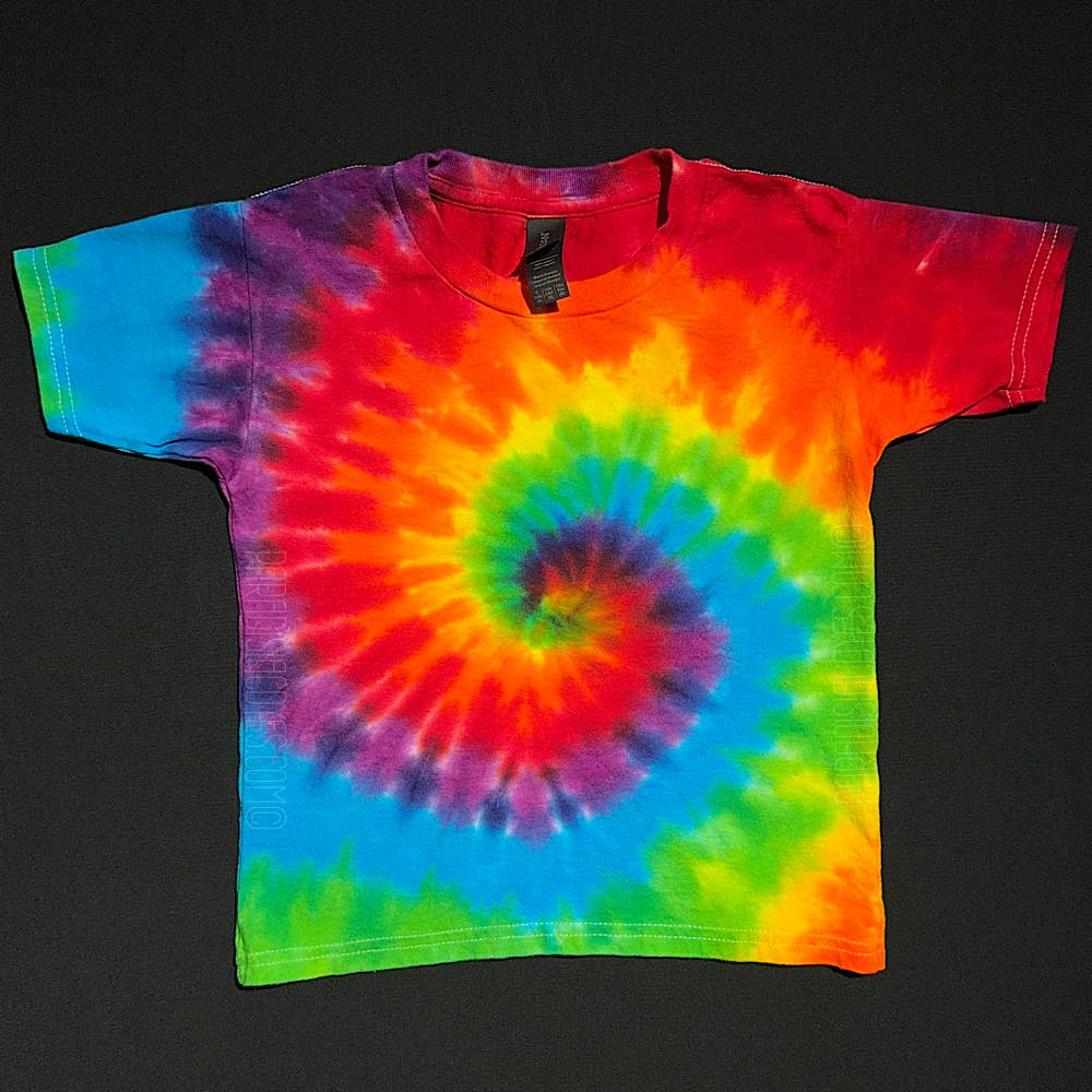 Pride rainbow spiral tie dye short sleeve shirt, laid flat on a solid black background.