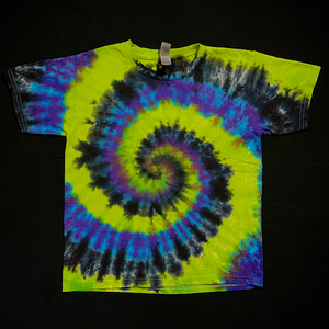 An example of a finished toddler sized black, green & purple spiral tie dye short sleeve t-shirt; laid flat on a solid black background 