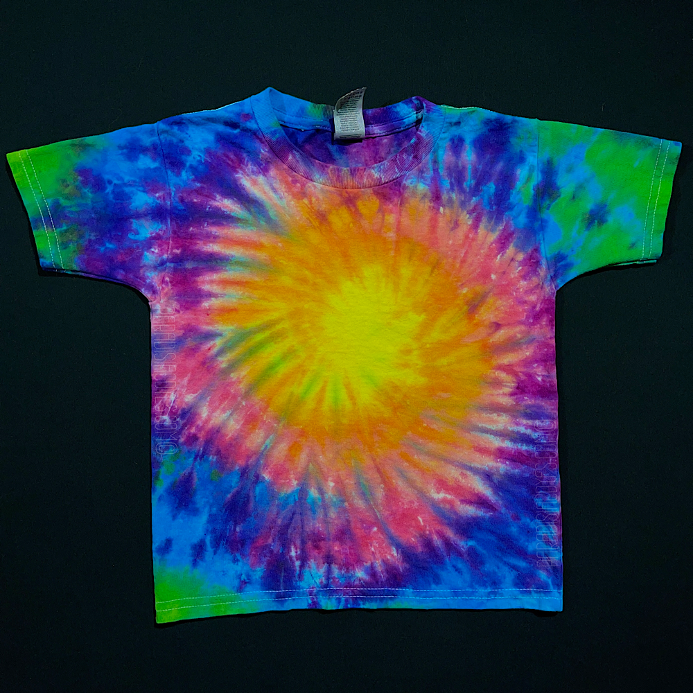 Another example of a children's size Neon Rainbow Sunburst short sleeve tie dye shirt design; laid flat on a solid black background 