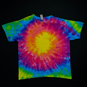 Another example of a different Neon Rainbow Sunburst toddler sized tie dye t-shirt design, featuring a bright yellow center with shades of peach, pink, magenta, electric blue & neon lime green radiating outward; laid flat on a solid black background