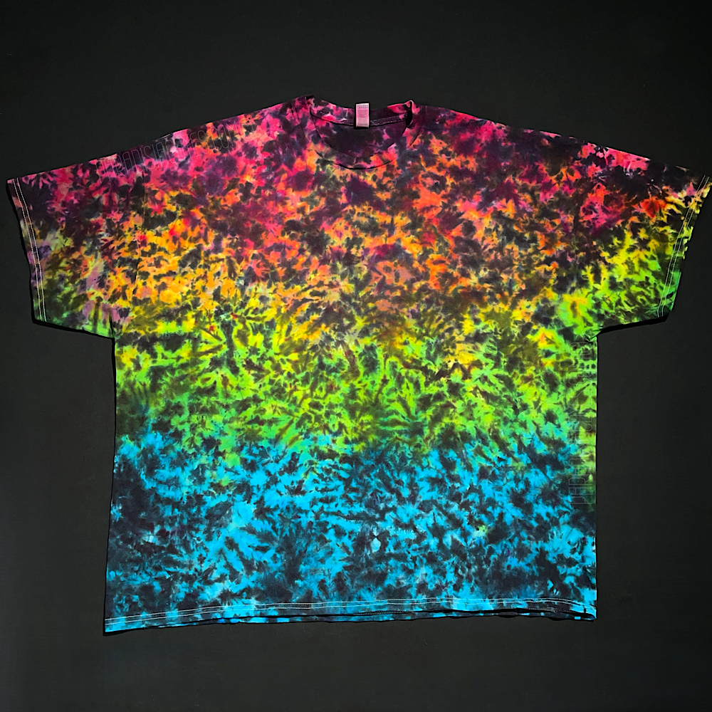 Another example of a finished Midnight Marbled Rainbow Ice Dye T-Shirt. The "base" of the design features a gradient of: pink, orange, fluorescent yellow, lime green & blue from top to bottom with a black splatter pattern on top.