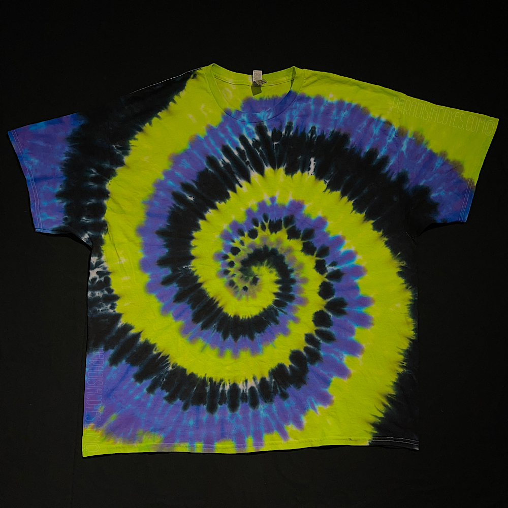 Another example of an actual, past Black, Green & Purple Spiral Tie Dye T-Shirt design before shipping; laid flat on a solid black background