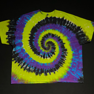 An example of an actual, finished Black, Green & Purple Spiral Tie Dye T-Shirt design before shipping; laid flat on a solid black background
