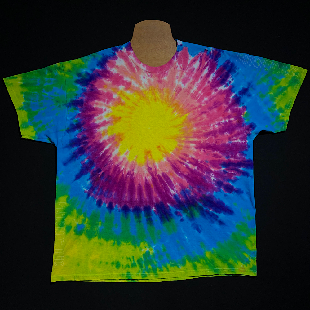 A neon rainbow sunburst tie dye design short sleeve shirt, designed for a center upper chest logo placement