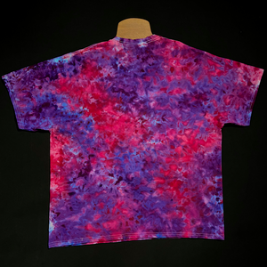 The back side of a finished pink & purple marbled ice tie-dyed t-shirt design; laid flat on a solid black background