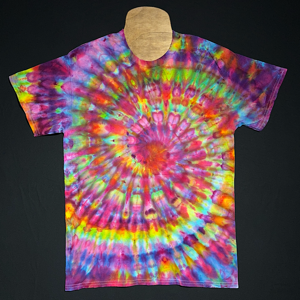 Front side of a rainbow confetti spiral ice dyed design on a short sleeve, crewneck style Gildan Ultra Cotton t-shirt. Each handmade-to-order tie dye shirt design comes out totally unique and is genuienly one of a kind.