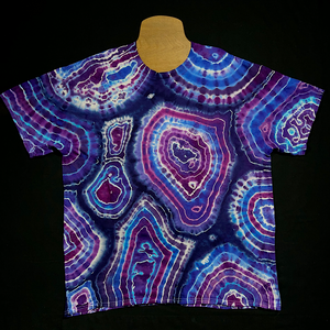 Front side of a different purple agate geode tie dye t-shirt; laid flat on a solid black background