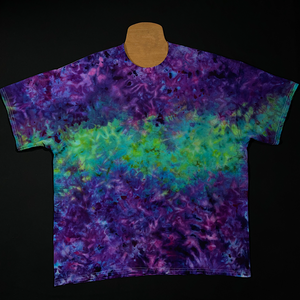 Front side of a handmade-to-order purple & mint green short sleeve tie dye t-shirt, featuring a marbled splatter ice dyed design
