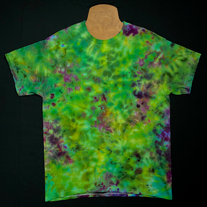 Another example of the finished results of yet another different Green & Purple marijuana bud inspired ice tie-dyed t-shirt design; laid flat on a solid black background
