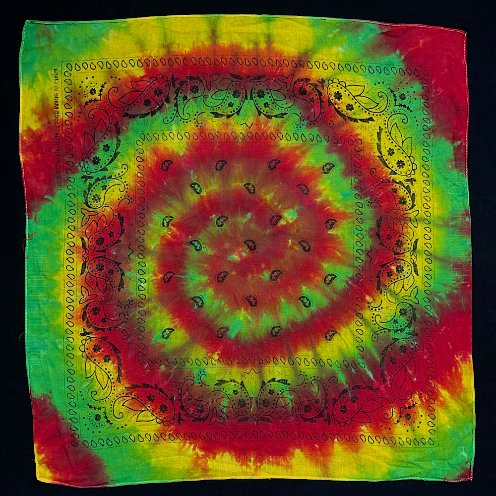 Red, yellow & green Rasta spiral tie dye bandana; laid flat on a solid black background
