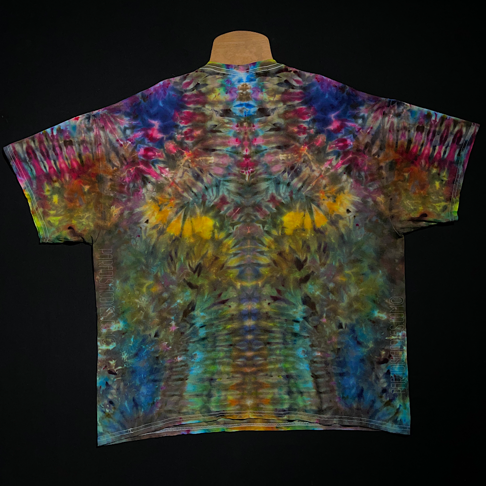 Front side of an abstract, symmetrical ice tie-dyed t-shirt design featuring a muted, rustic rainbow color scheme
